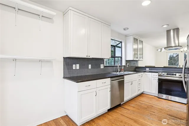 a kitchen with stainless steel appliances granite countertop a sink and cabinets