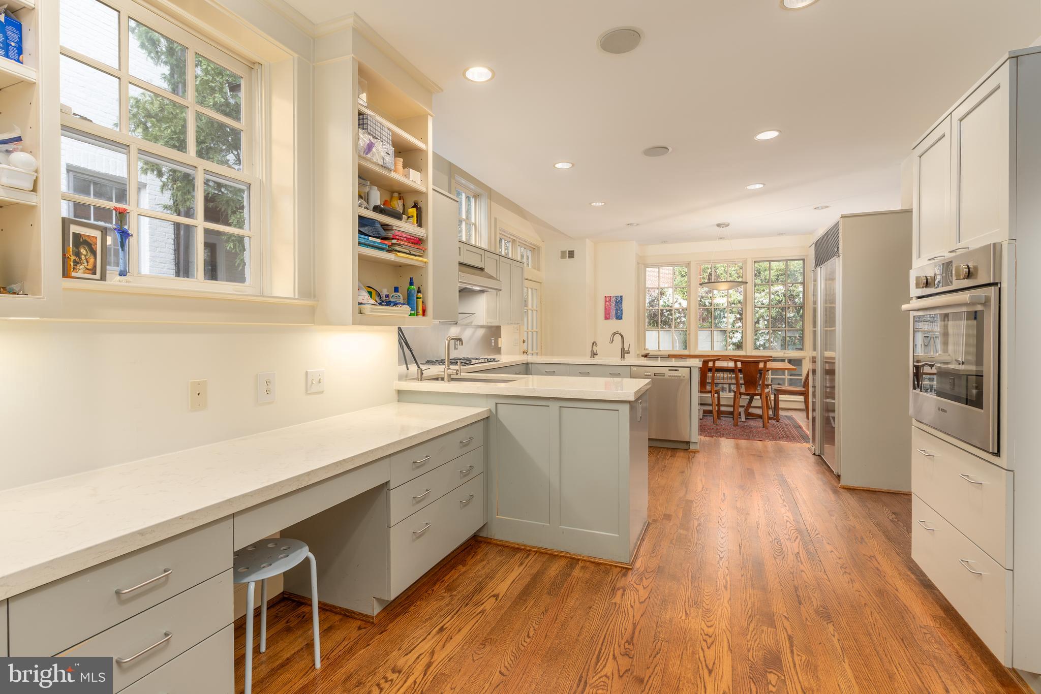 3415 Fulton Street Northwest Washington, DC 20007 - Photo 15 of 68 a kitchen with stainless steel appliances granite countertop a sink cabinets and wooden floor