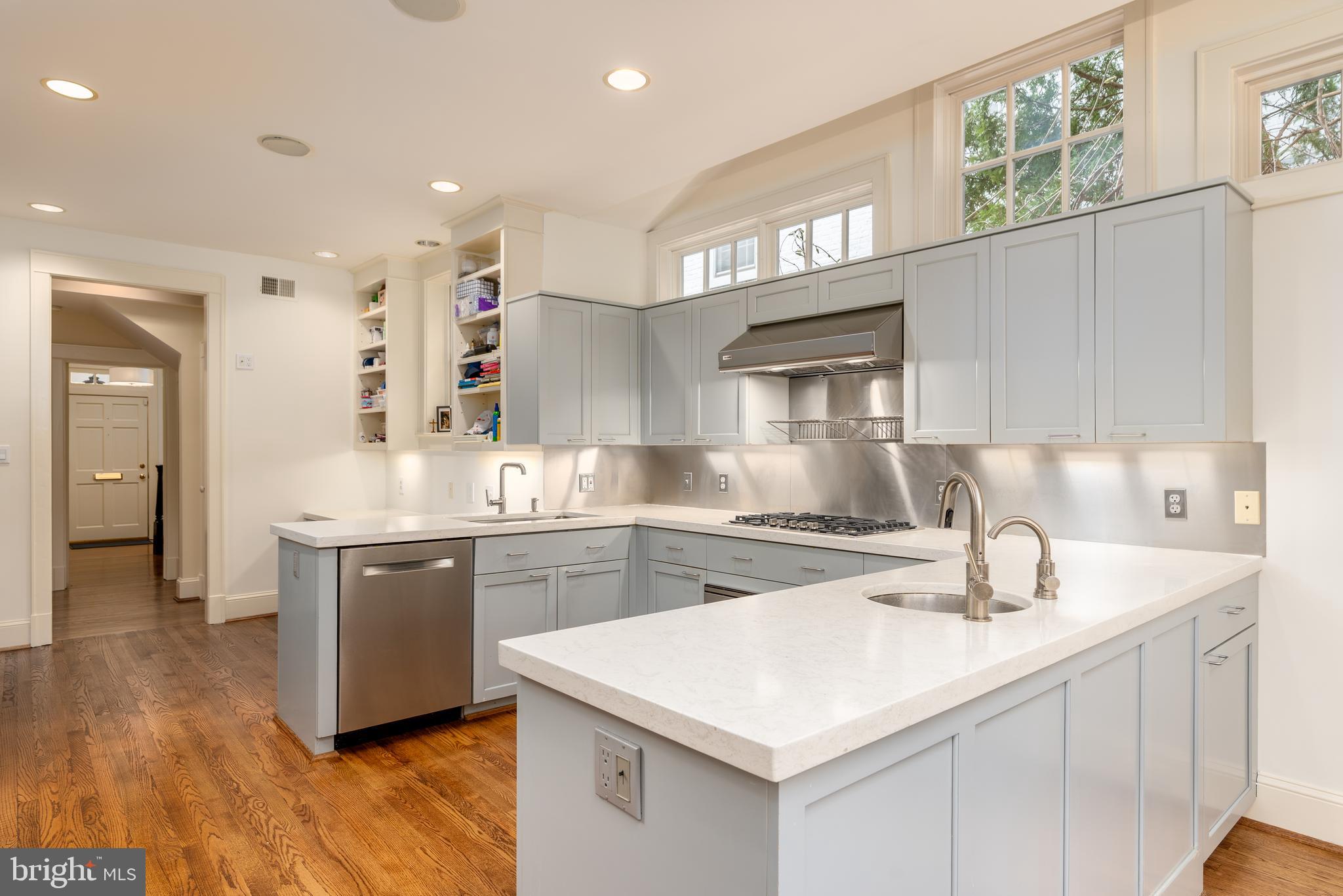 3415 Fulton Street Northwest Washington, DC 20007 - Photo 18 of 68 a kitchen with stainless steel appliances granite countertop a sink stove and refrigerator