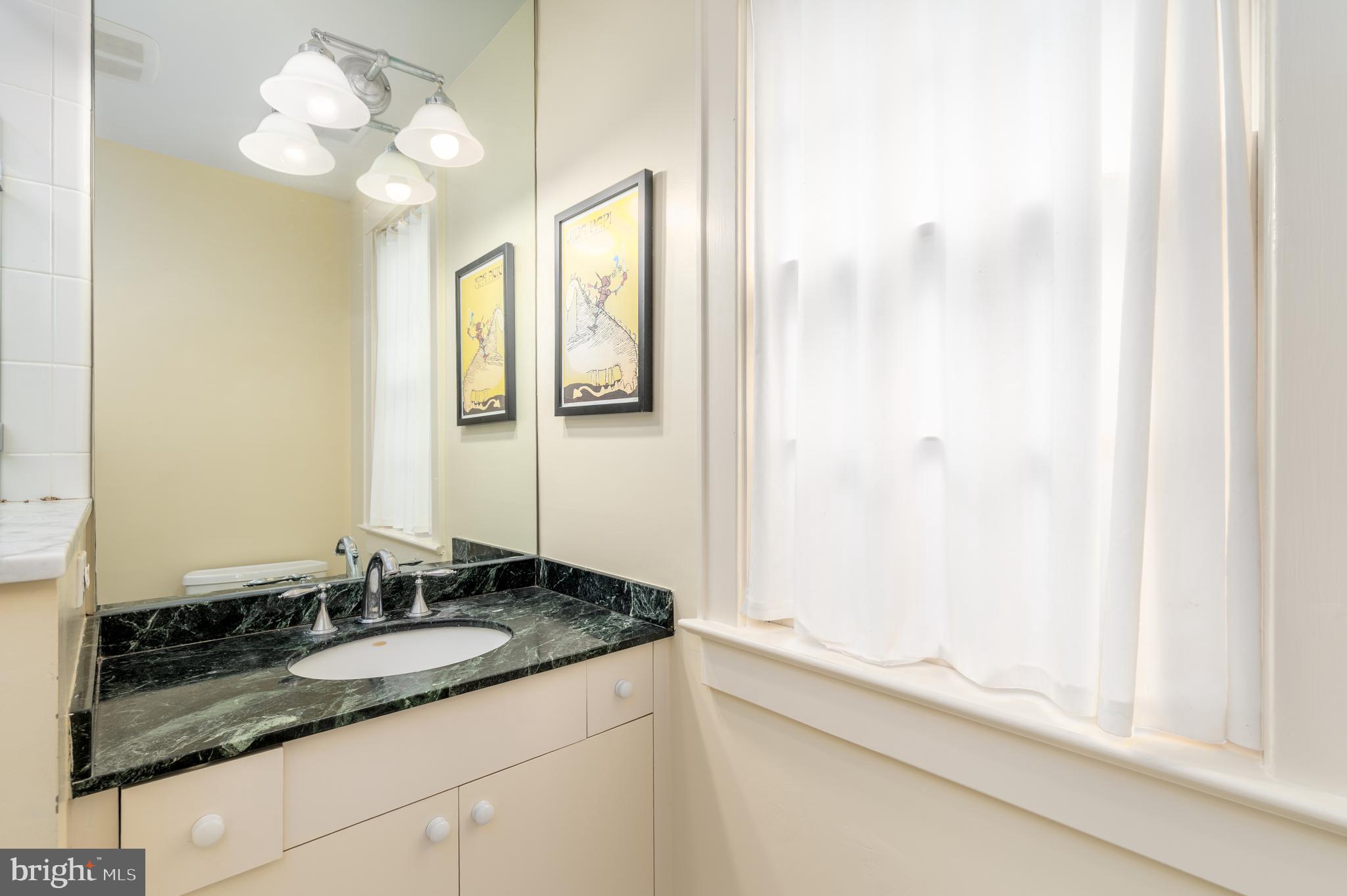 3415 Fulton Street Northwest Washington, DC 20007 - Photo 39 of 68 a bathroom with a granite countertop sink and a mirror