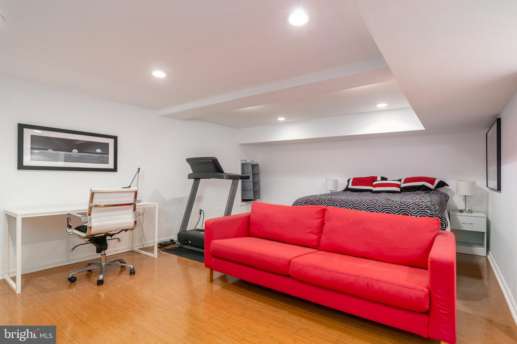 3415 Fulton Street Northwest Washington, DC 20007 - Photo 51 of 68 a living room with furniture gym equipment and a flat screen tv