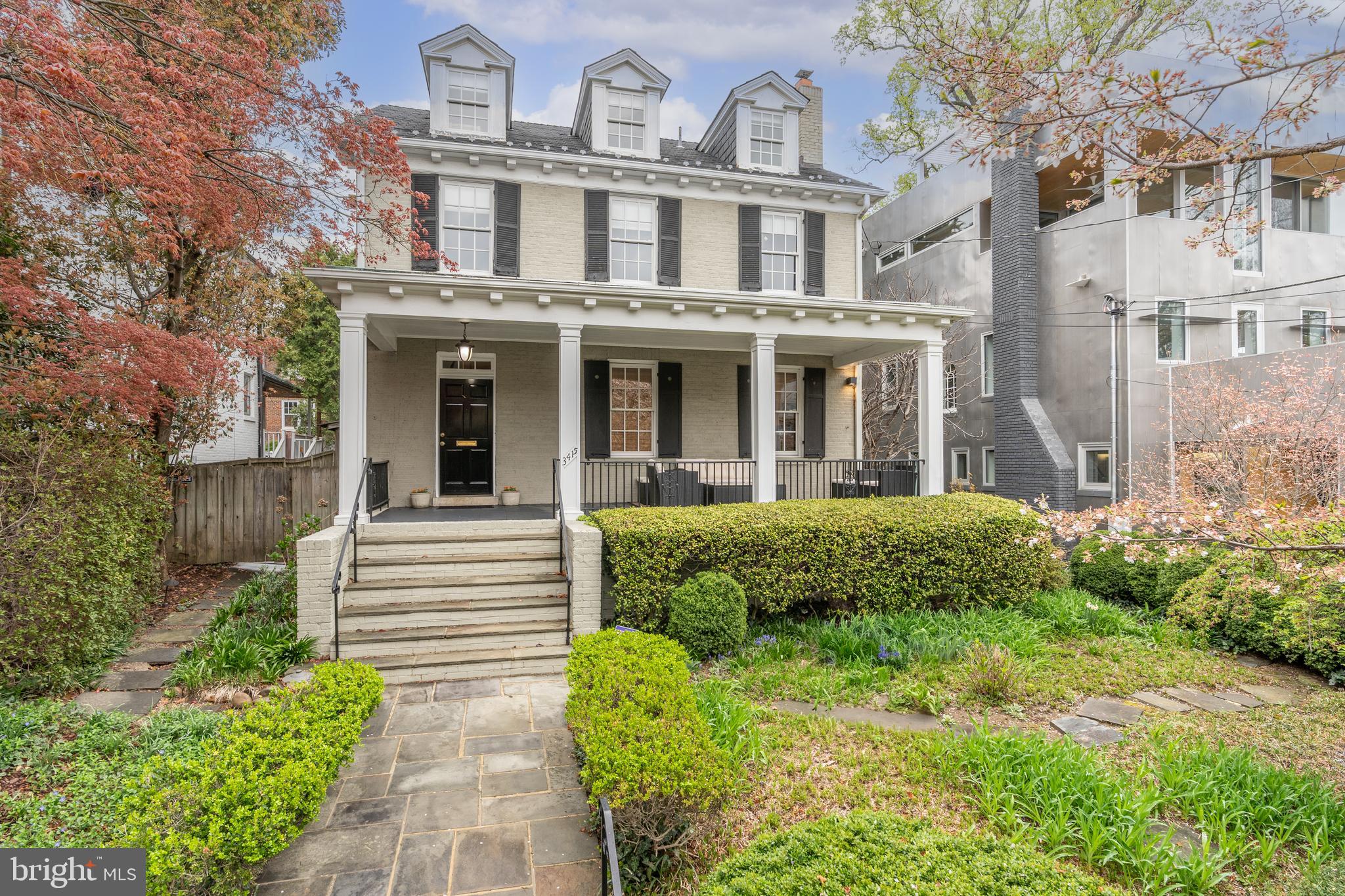 3415 Fulton Street Northwest Washington, DC 20007 - Photo 52 of 68 a view of a white house with large windows and a small yard