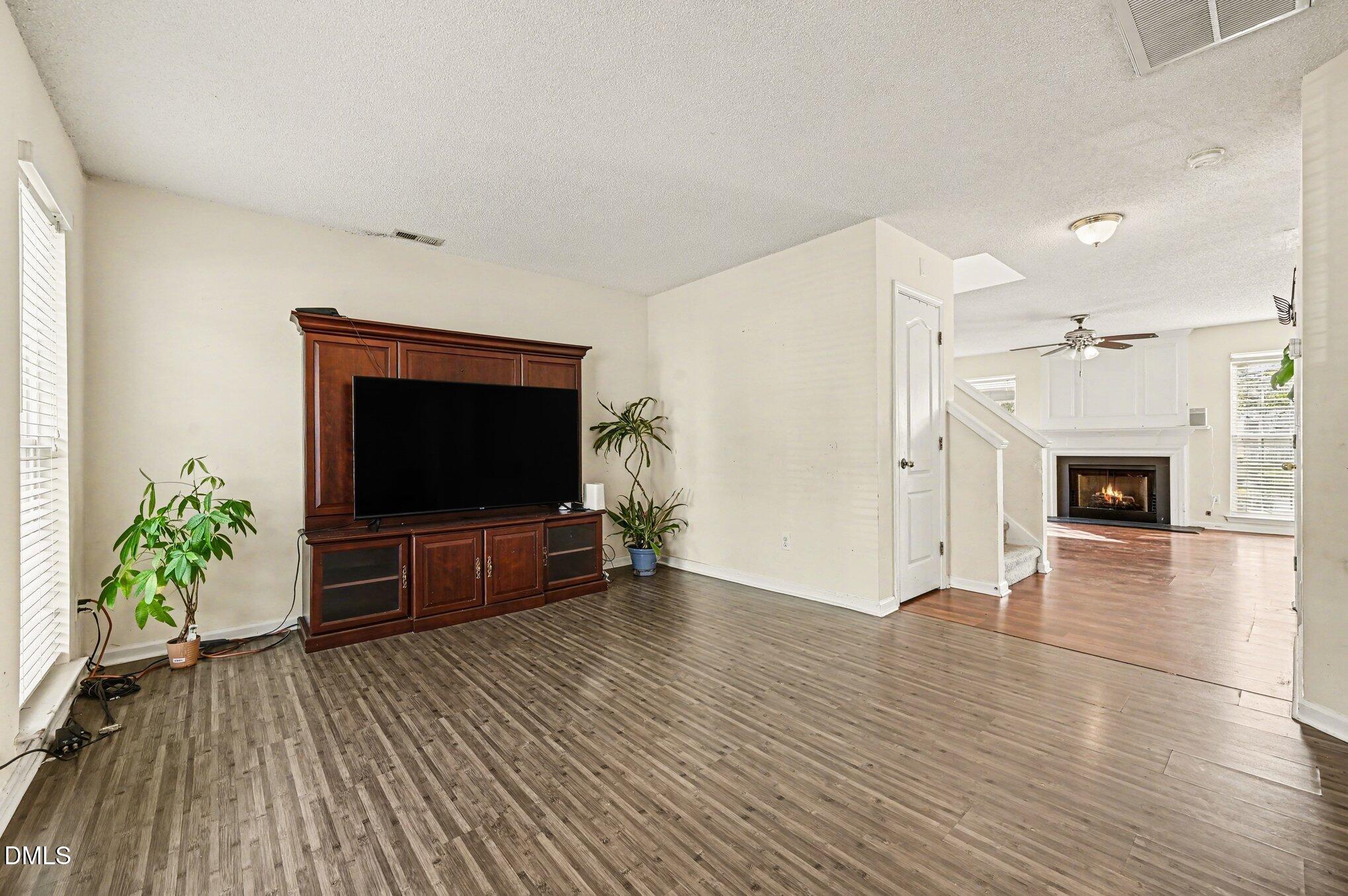 5115 Cardinal Grove Boulevard Raleigh, NC 27616 - Photo 8 of 36 a living room with furniture and a flat screen tv