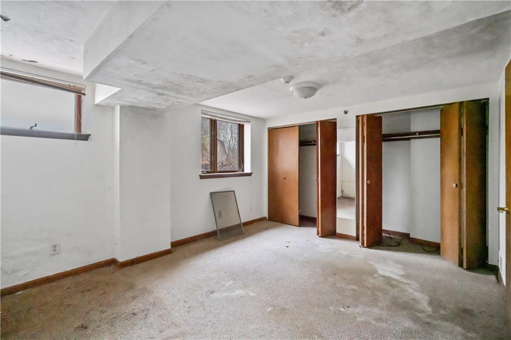 134 Becks Run Road Coraopolis, PA 15108 - Photo 16 of 26 Lower level bedroom. A window had been broken and not discovered right away so water got in. Window has been covered.