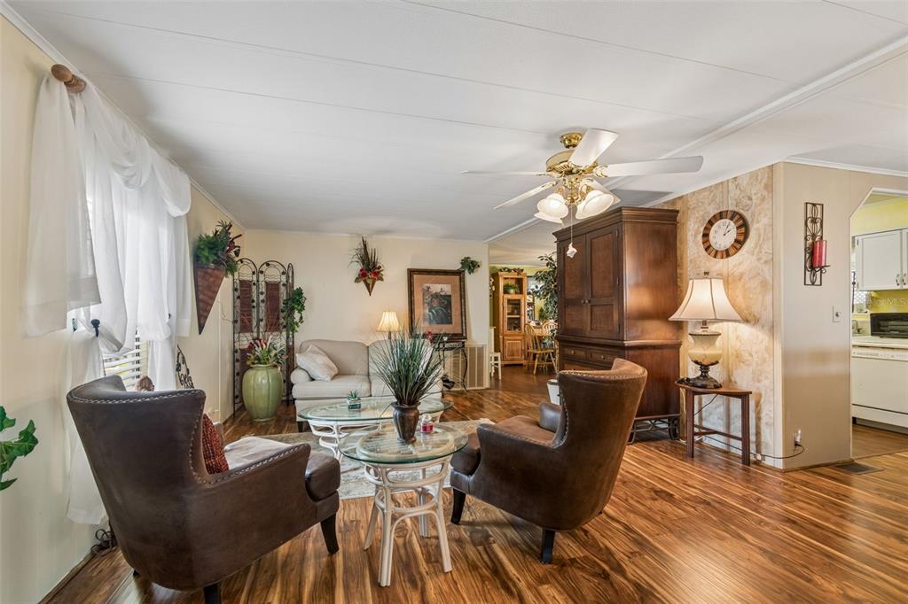 12501 Ulmerton Road, Unit 175 Largo, FL 33774 - Photo 4 of 32 a living room with furniture a chandelier and a window