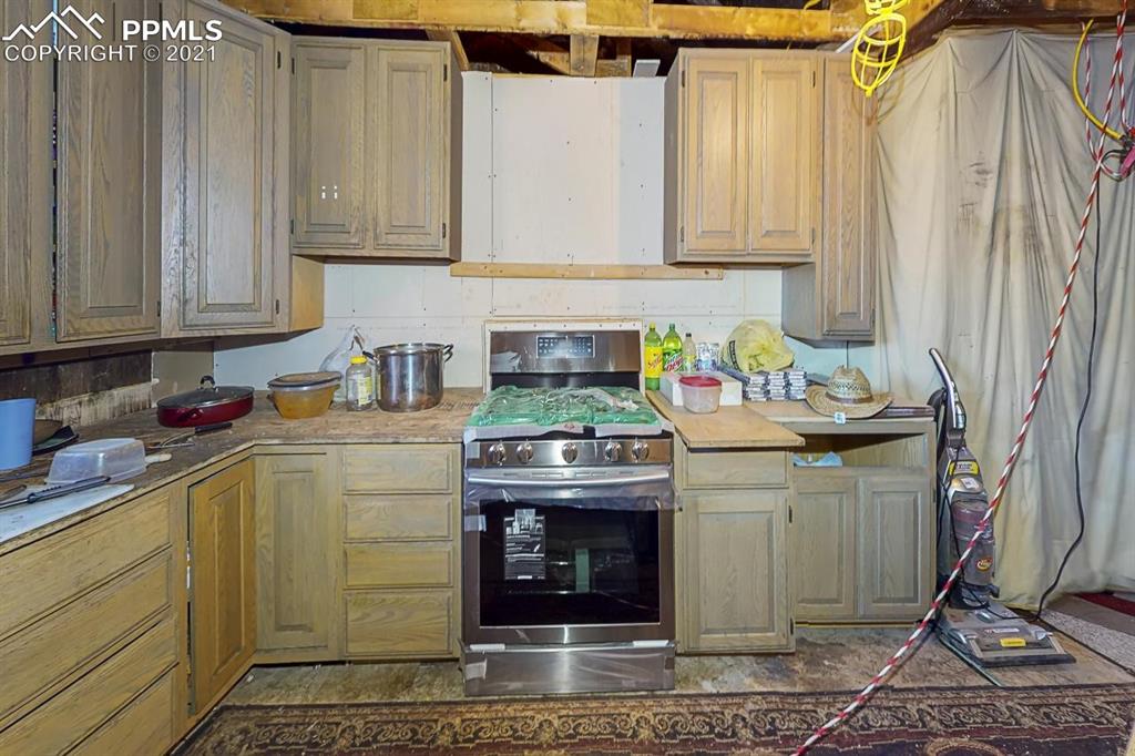 511 Buffalo Street Simla, CO 80835 - Photo 16 of 17 a kitchen with a stove and cabinets