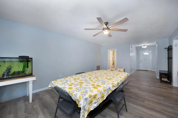 a view of a dining room with furniture and wooden floor