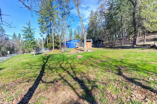 a view of a wooden house with a yard