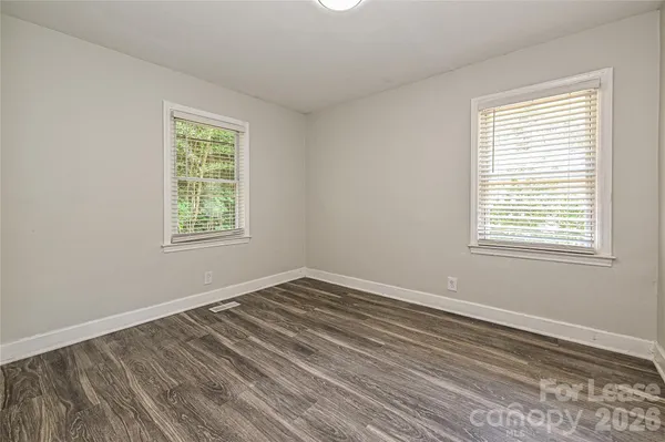a bathroom with a granite countertop sink a toilet and bathtub