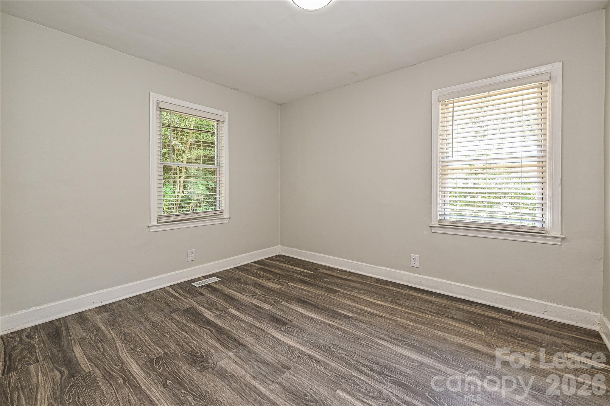 3429 Tappan Place, Unit 2 Charlotte, NC 28205 - Photo 11 of 16 a view of an empty room with wooden floor and a window