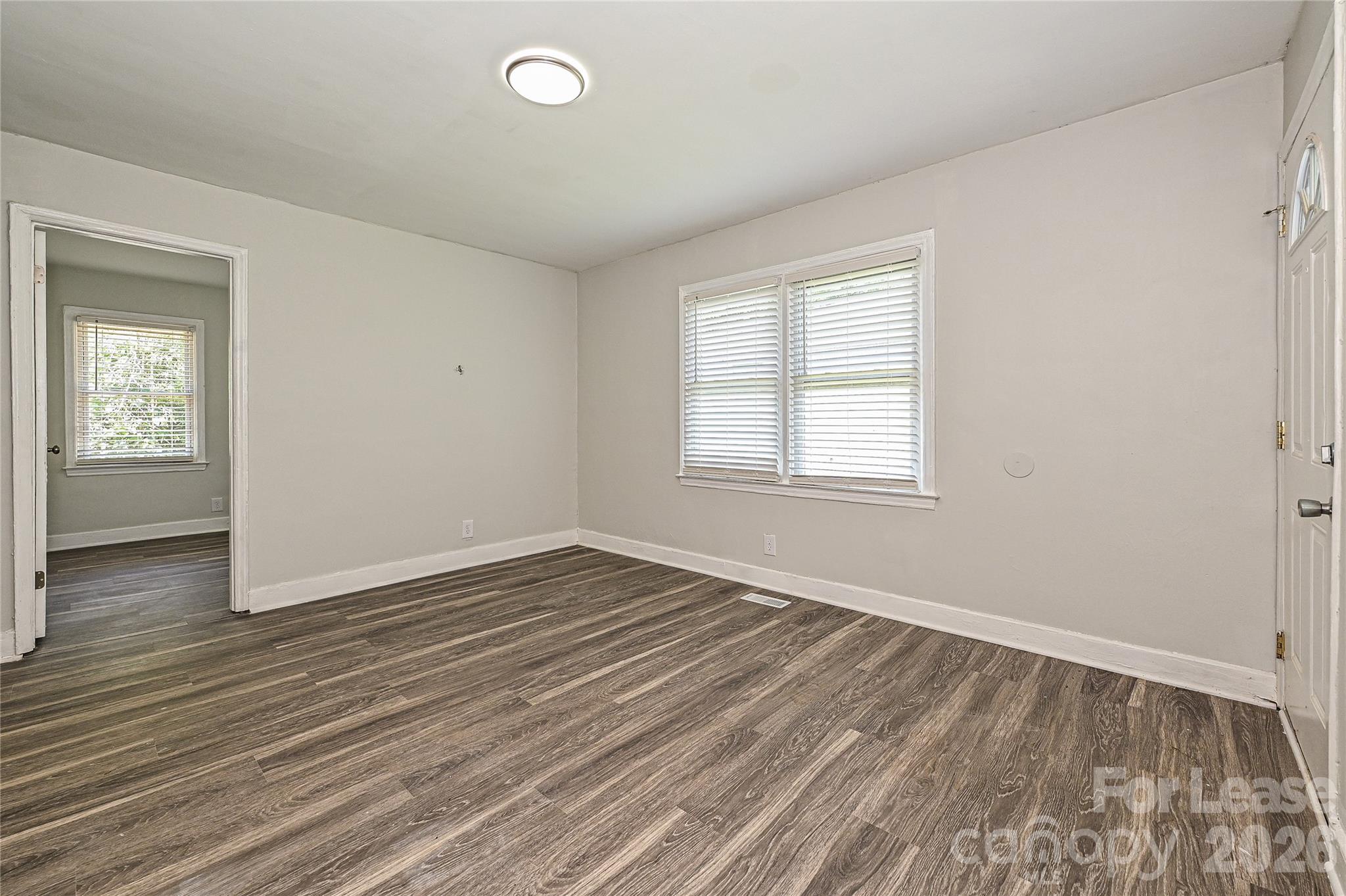 3429 Tappan Place, Unit 2 Charlotte, NC 28205 - Photo 3 of 16 an empty room with wooden floor and windows