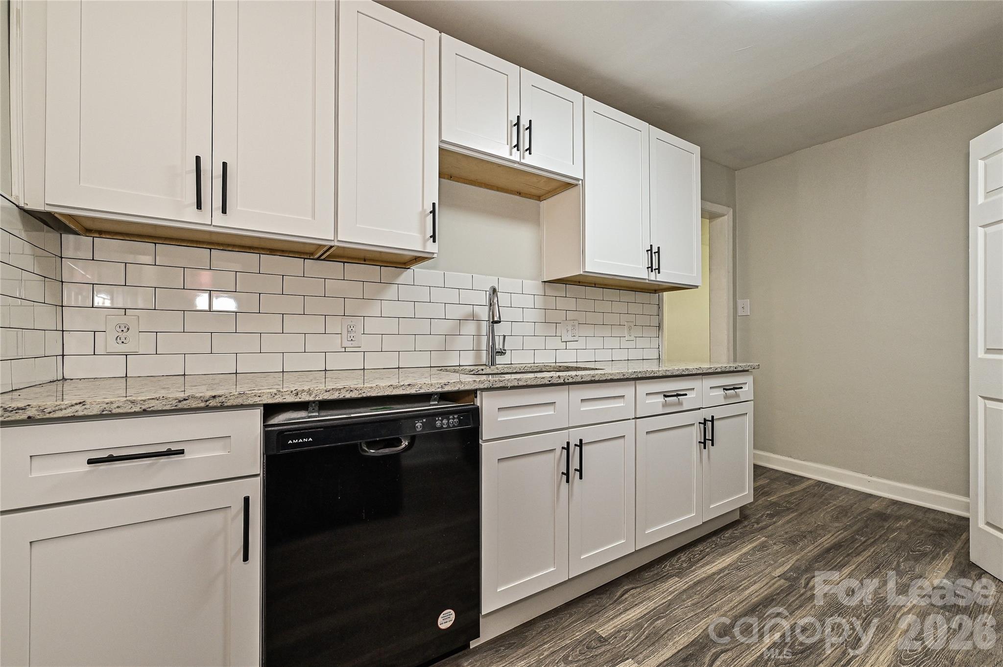 3429 Tappan Place, Unit 2 Charlotte, NC 28205 - Photo 10 of 16 a kitchen with granite countertop white cabinets and white appliances