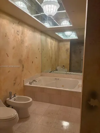 a bathroom with a toilet a sink and bathtub