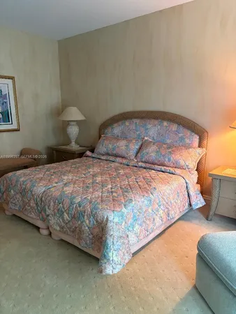 a bedroom with a bed and lamp