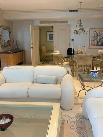 a living room with furniture a chandelier and a fireplace