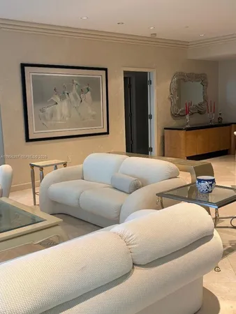 a living room with furniture and a wall painting