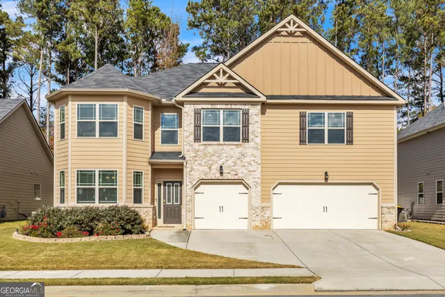 a living room with furniture a chandelier and a potted plant