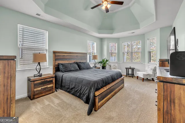 a view of a house with a big yard and large tree