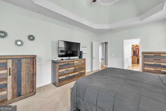 a living room with furniture and a floor to ceiling window