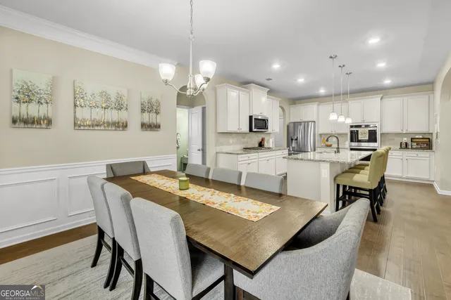 a bathroom with a tub a sink and a mirror