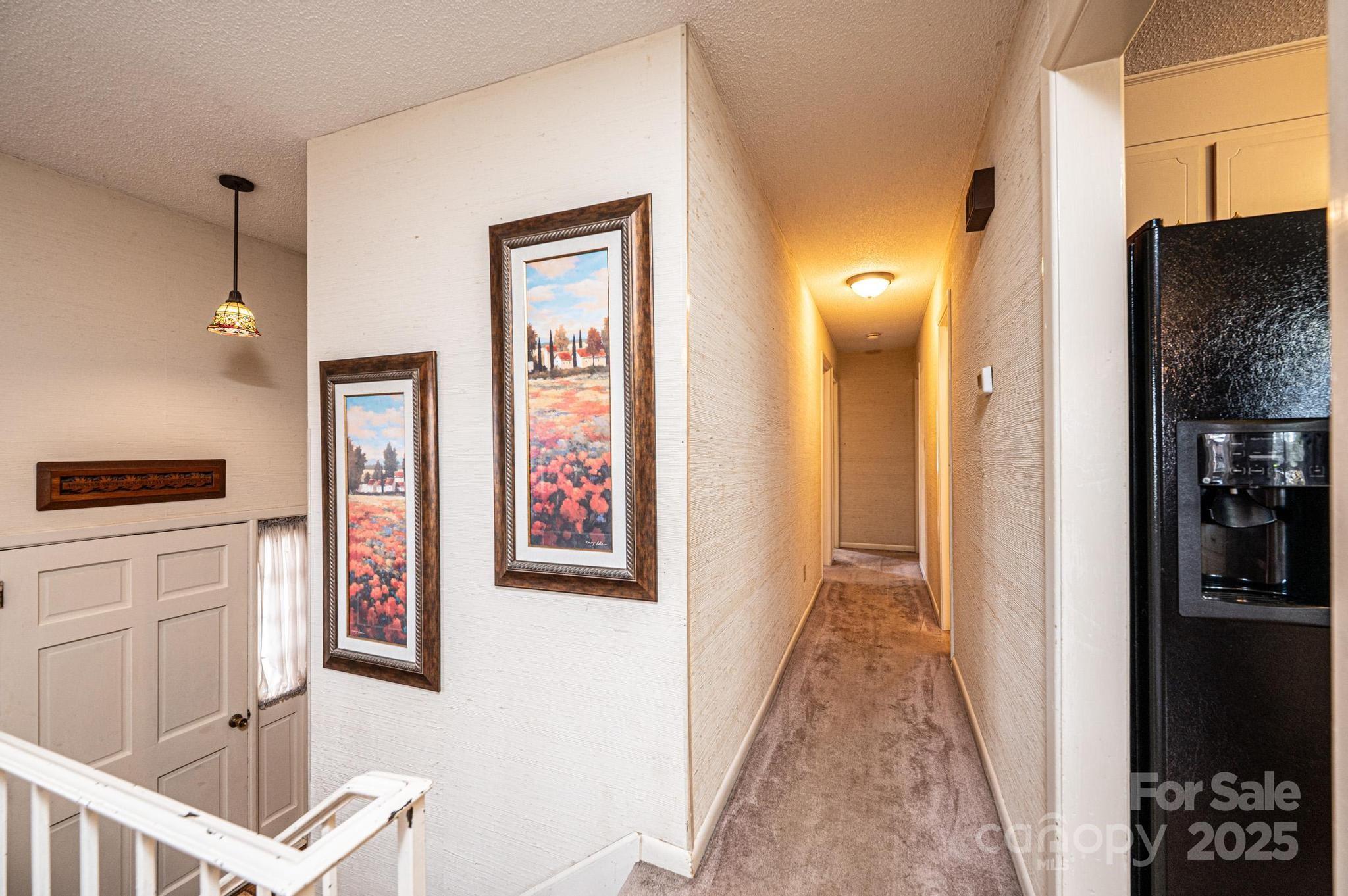 2570 Raintree Street Connelly Springs, NC 28612 - Photo 12 of 37 a view of a hallway with wooden floor and dining room