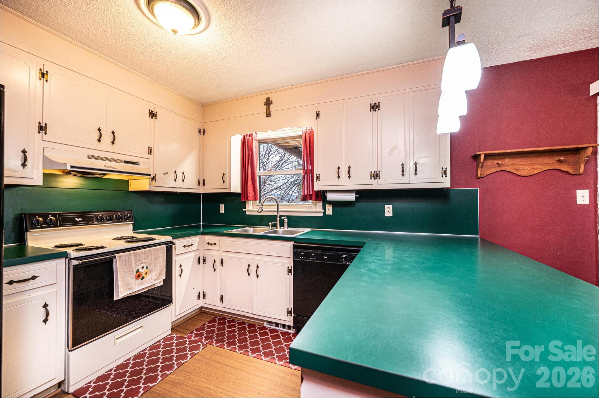 2570 Raintree Street Connelly Springs, NC 28612 - Photo 12 of 39 a kitchen with stainless steel appliances granite countertop a stove a sink and a microwave