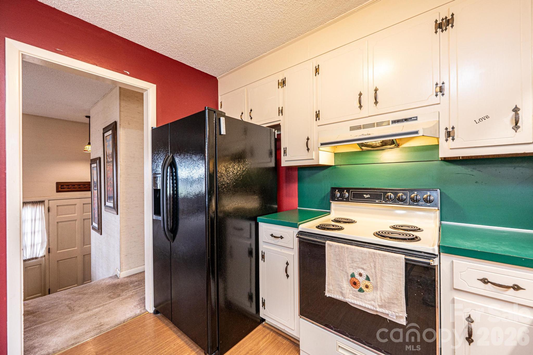 2570 Raintree Street Connelly Springs, NC 28612 - Photo 14 of 39 a kitchen with a refrigerator and a stove