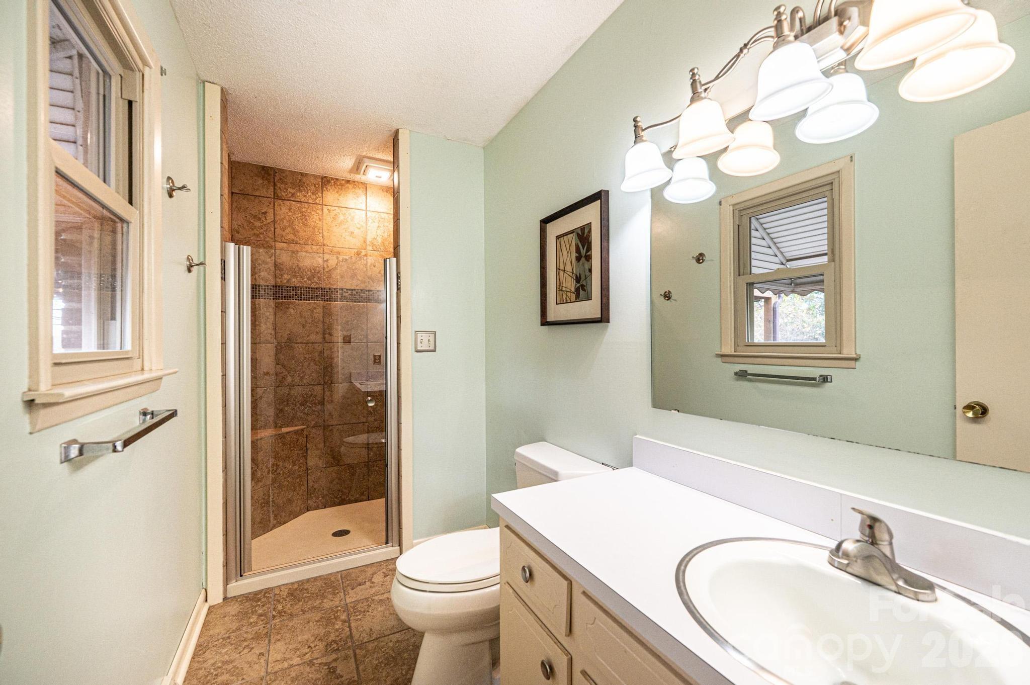 2570 Raintree Street Connelly Springs, NC 28612 - Photo 18 of 39 a bathroom with a sink a toilet and shower