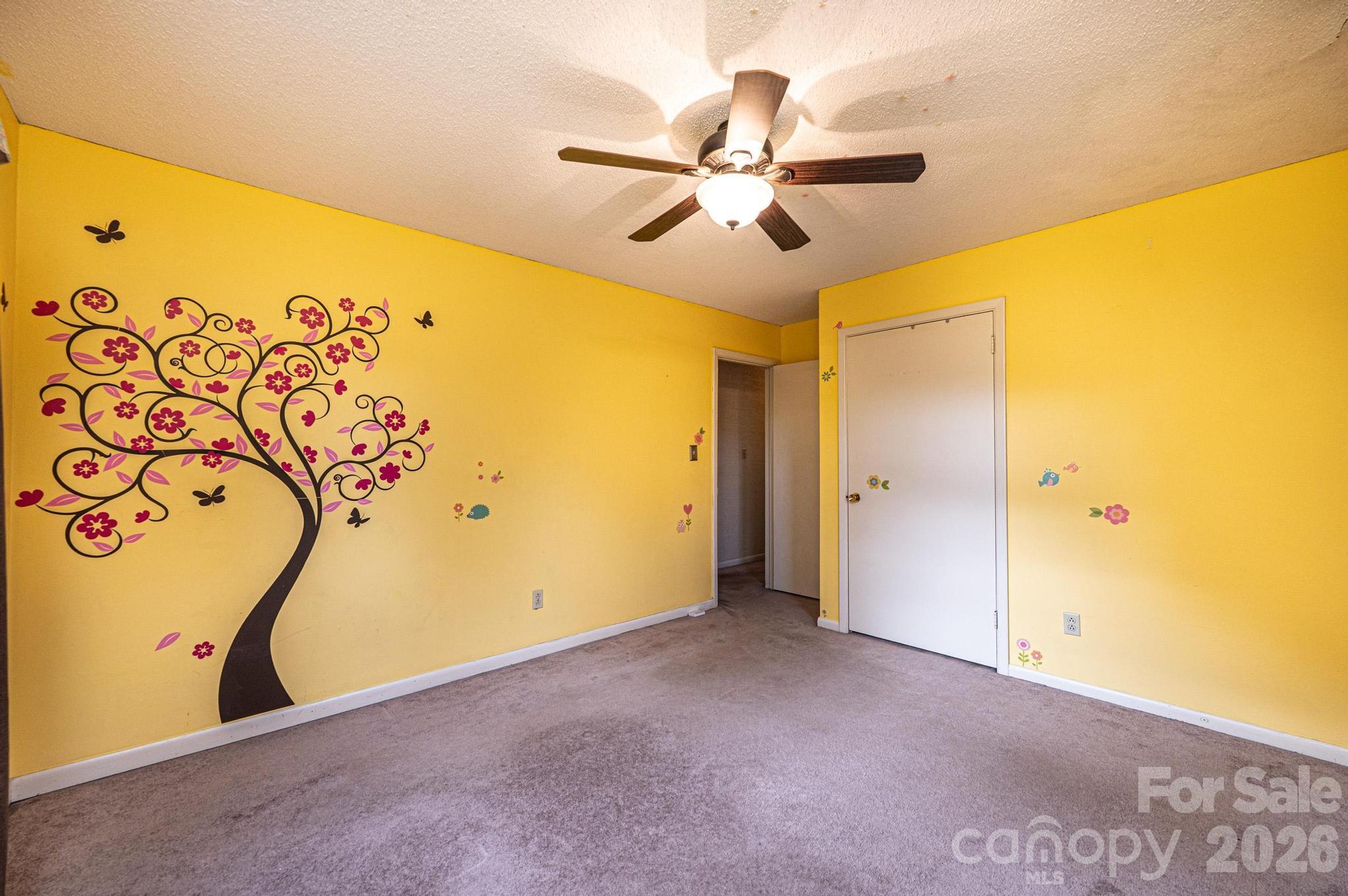 2570 Raintree Street Connelly Springs, NC 28612 - Photo 19 of 39 a view of a big room with a window and a ceiling fan