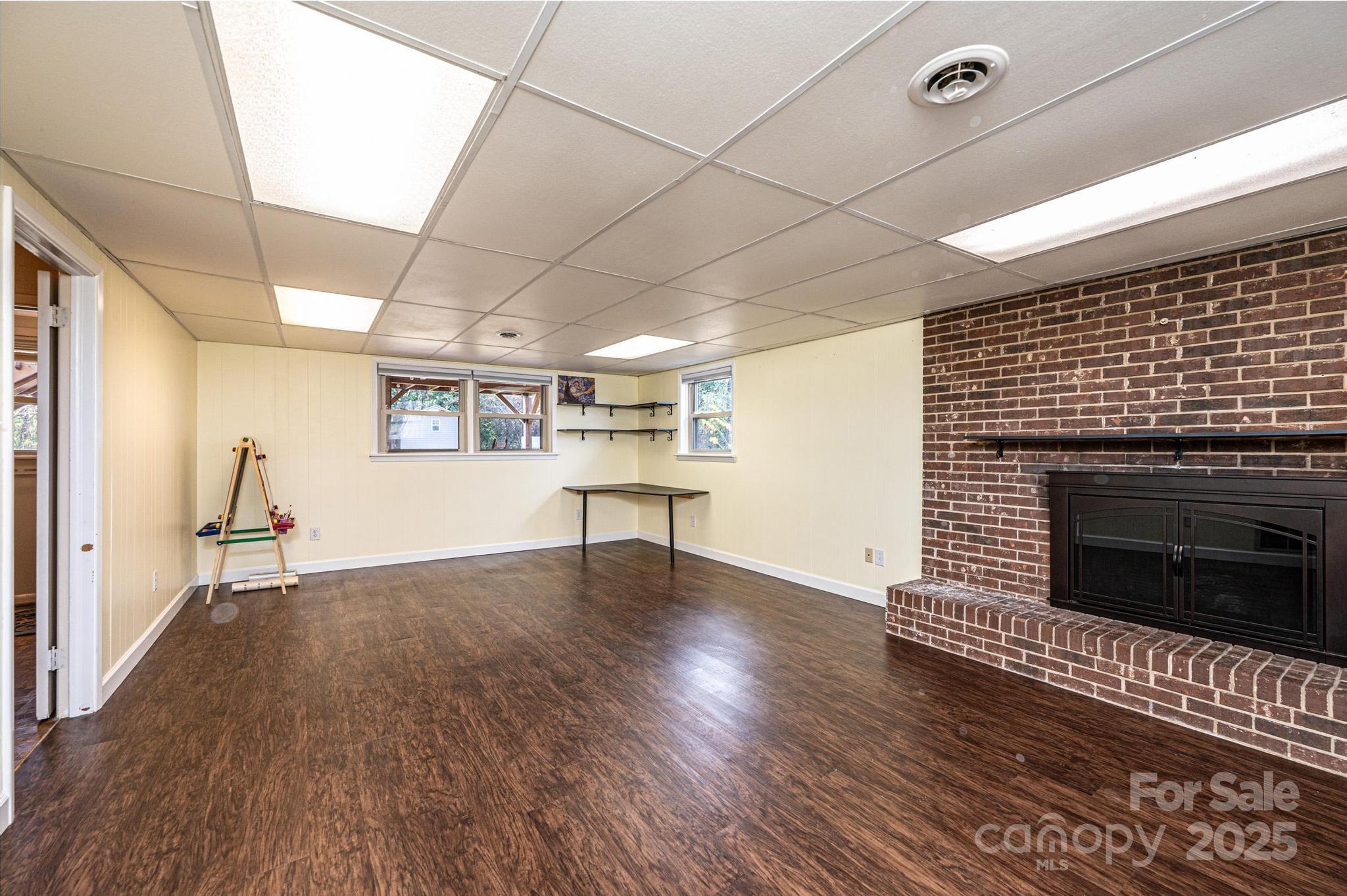 2570 Raintree Street Connelly Springs, NC 28612 - Photo 21 of 37 a view of empty room with wooden floor and fireplace