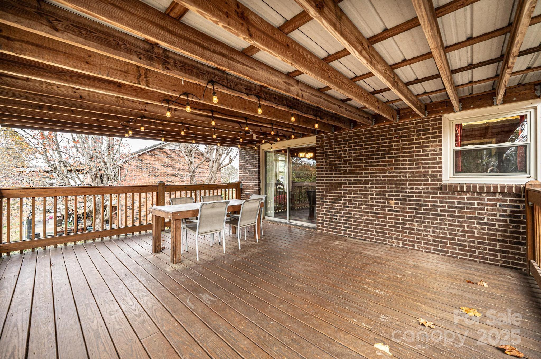 2570 Raintree Street Connelly Springs, NC 28612 - Photo 28 of 37 a view of a patio with table and chairs with wooden floor