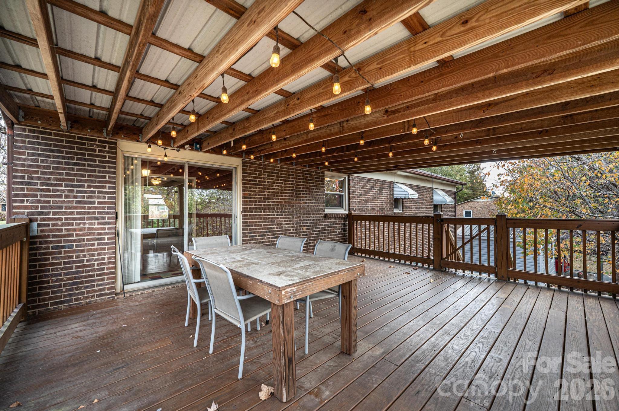 2570 Raintree Street Connelly Springs, NC 28612 - Photo 29 of 39 a patio with wooden floors a table and chairs