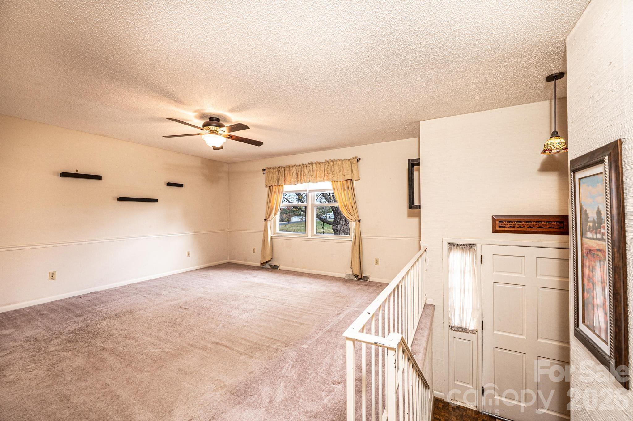 2570 Raintree Street Connelly Springs, NC 28612 - Photo 3 of 39 a view of a livingroom with wooden floor and stairs