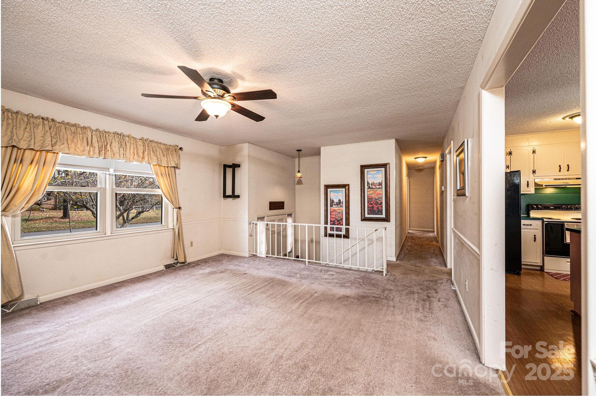 2570 Raintree Street Connelly Springs, NC 28612 - Photo 4 of 37 a view of empty room with wooden floor and fan