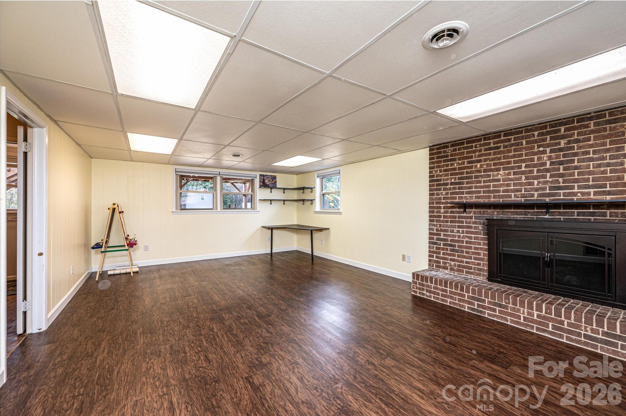 2570 Raintree Street Connelly Springs, NC 28612 - Photo 5 of 39 a view of empty room with wooden floor and fireplace