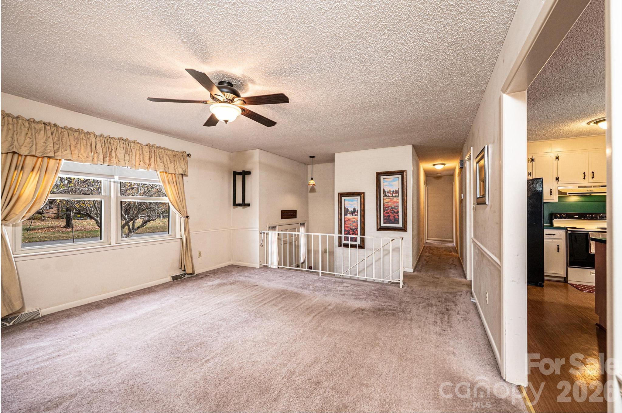 2570 Raintree Street Connelly Springs, NC 28612 - Photo 8 of 39 a view of empty room with wooden floor and fan