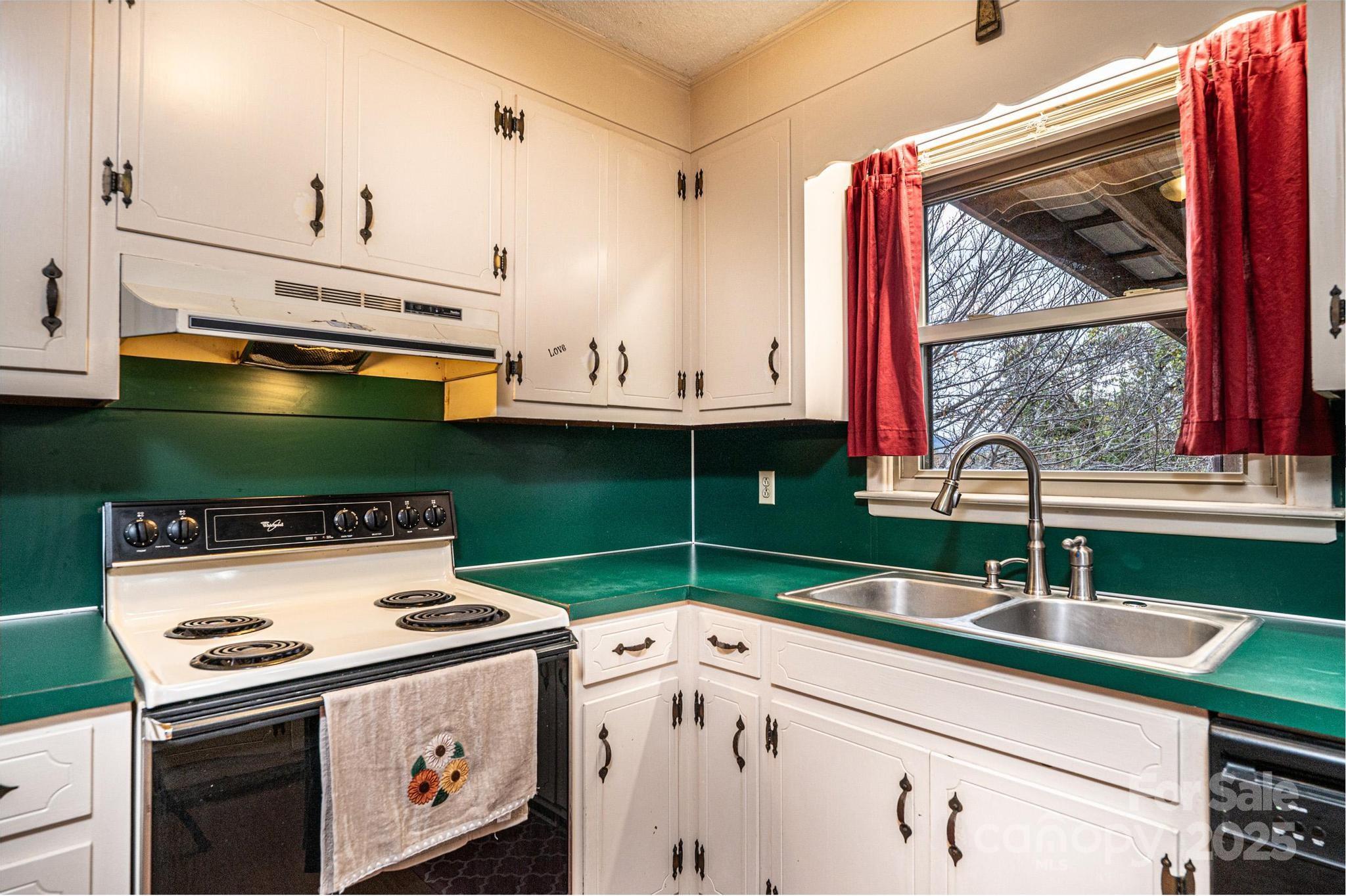 2570 Raintree Street Connelly Springs, NC 28612 - Photo 10 of 37 a kitchen with a sink stove and cabinets