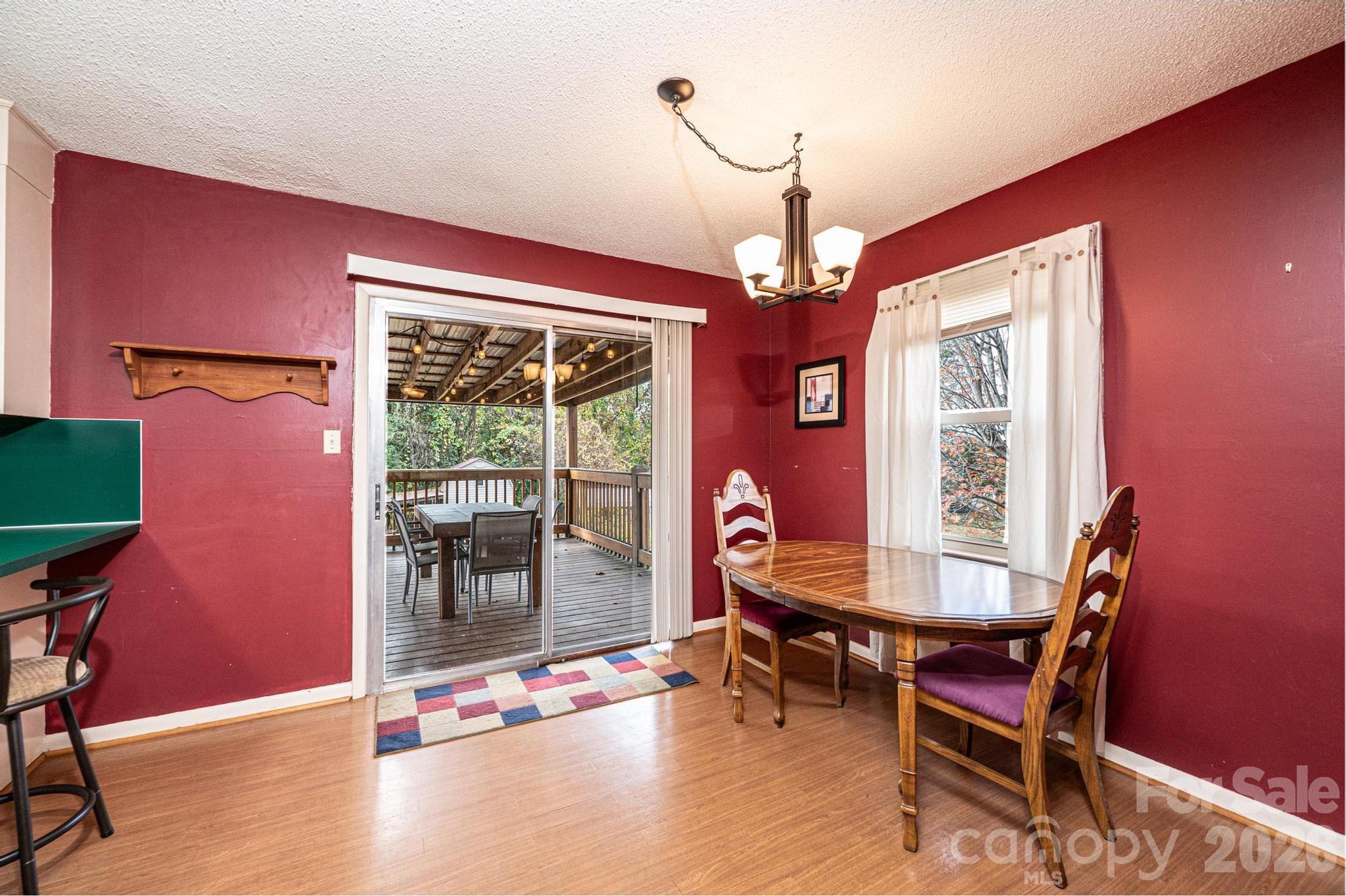 2570 Raintree Street Connelly Springs, NC 28612 - Photo 10 of 39 a dining room with furniture a chandelier and wooden floor