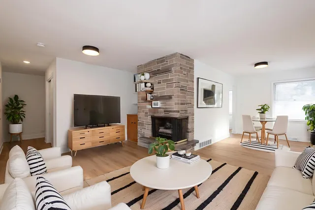 a living room with furniture flat screen tv and a fireplace