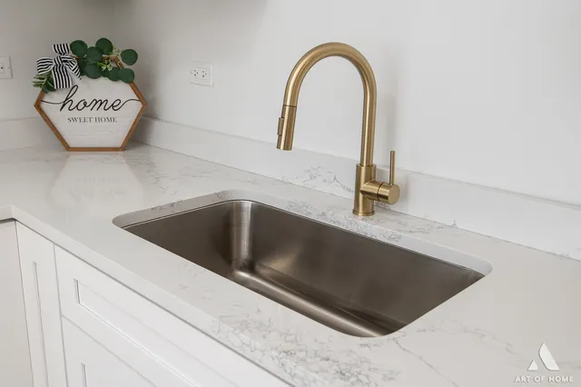 a kitchen with a refrigerator cabinets and wooden floor