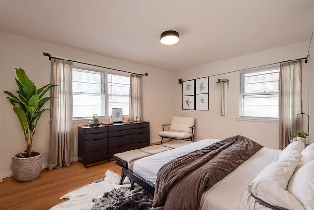 a view of a room with wooden floor and windows in it