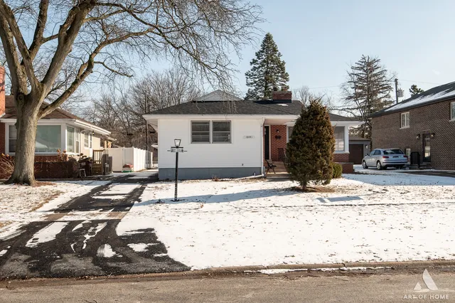 a view of a house with snow on the road