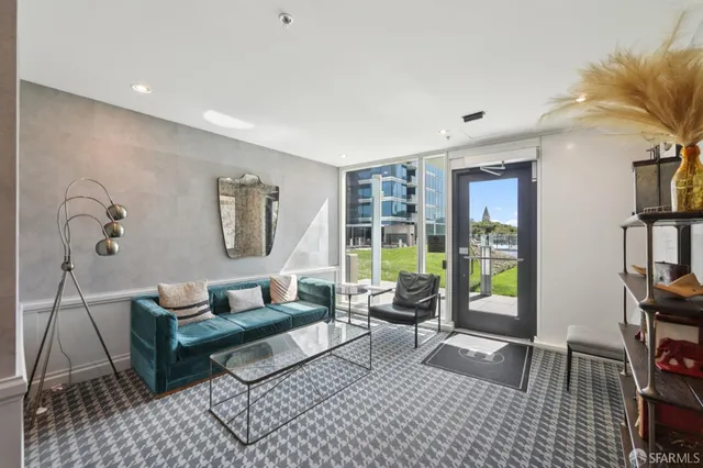 a large white kitchen with a large counter top space a sink and stainless steel appliances