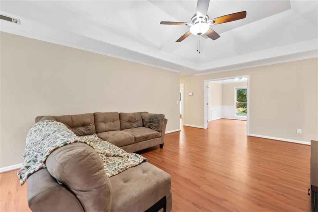 2985 Ashton Pointe Circle Dacula, GA 30019 - Photo 11 of 47 a living room with furniture and a chandelier
