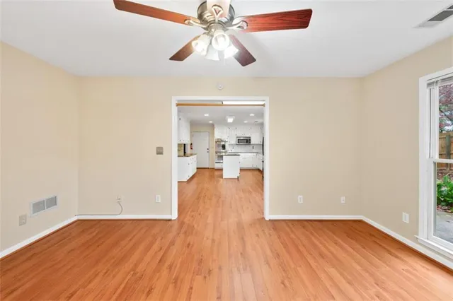 wooden floor in an empty room with a window