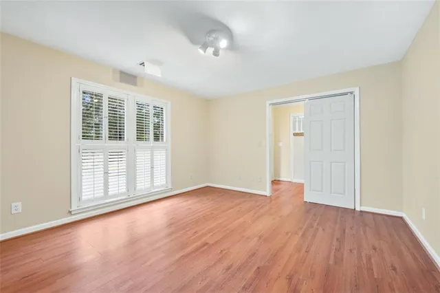 wooden floor in an empty room with a window