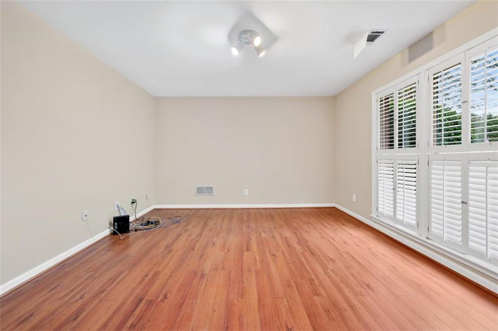 2985 Ashton Pointe Circle Dacula, GA 30019 - Photo 21 of 47 an empty room with wooden floor and windows