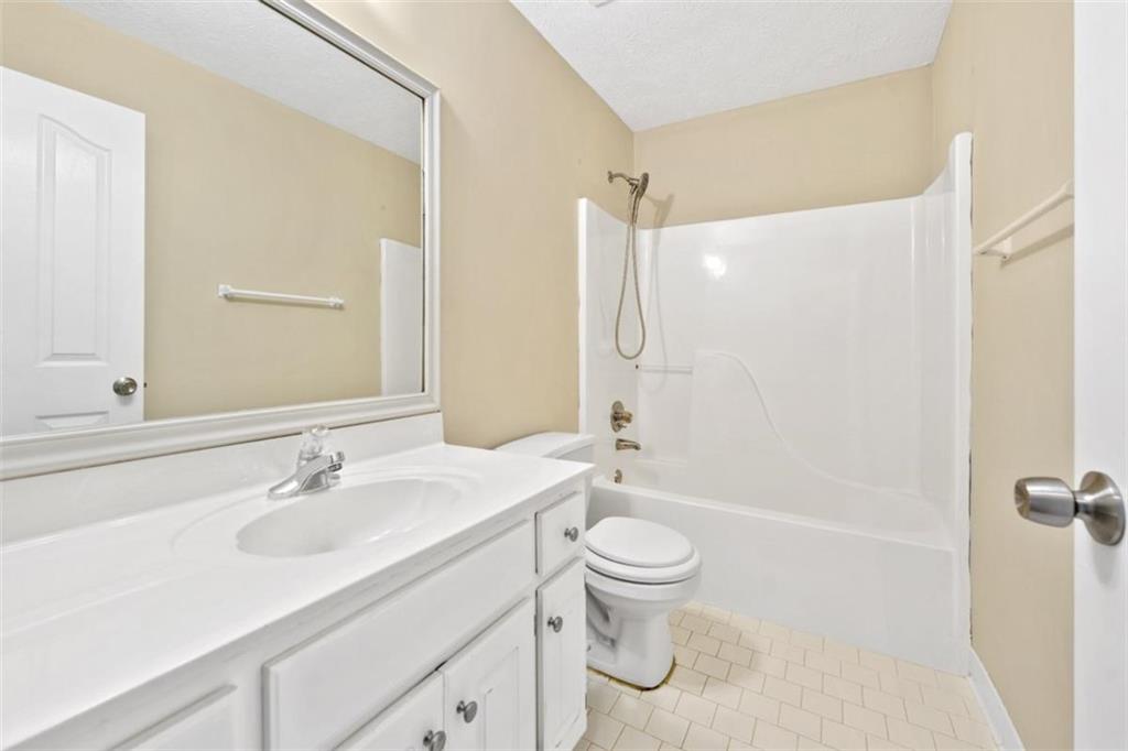 2985 Ashton Pointe Circle Dacula, GA 30019 - Photo 25 of 47 a bathroom with a sink a toilet and shower