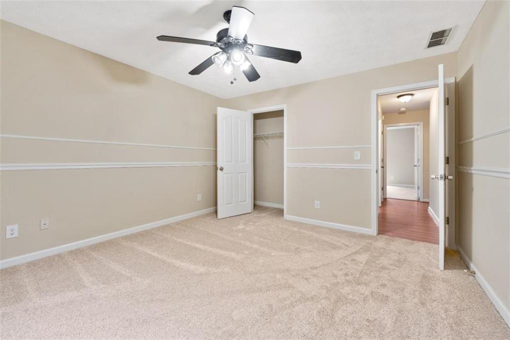 2985 Ashton Pointe Circle Dacula, GA 30019 - Photo 27 of 47 an empty room with closet and a ceiling fan