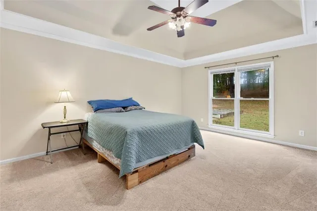 a spacious bedroom with a bed and a window